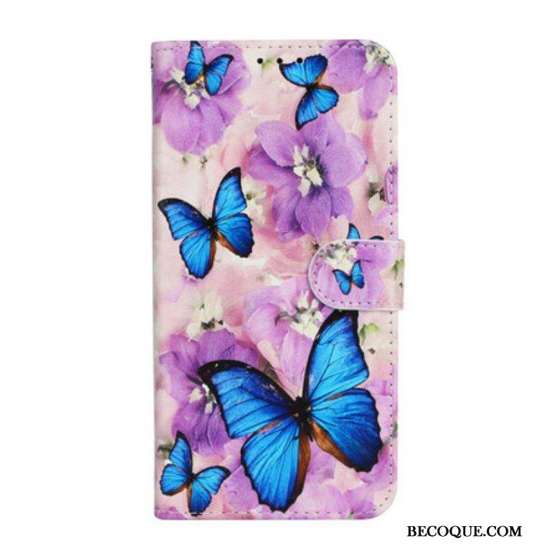 Housse iPhone 13 Mini Papillons Bleus dans les Fleurs